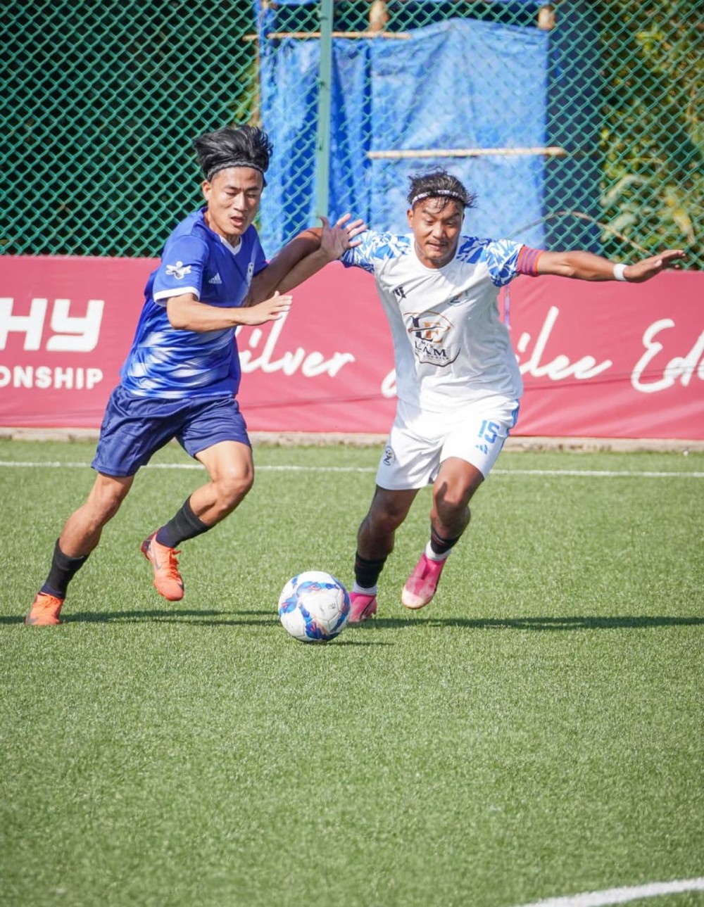 Players of Noklak (white) and Kiphire (blue) vie for the ball during the football match no. 17 of the ongoing 25th Dr T Ao Trophy at Renpo Lu Sports Complex, Ungma in Mokokchung on October 19.